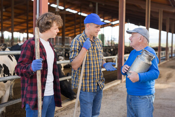 Fototapeta na wymiar Dairy farm workers talk to each other during a break