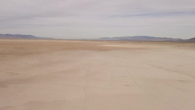 Global warming parched earth drought landscape in Arizona on a dry lake bed, aerial panning shot