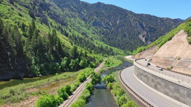 Aerial drone shot of Provo River in mountain canyon with highway in Utah summer