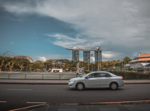 Gray Car Driving In The Street With Marina Bay Sands In The Background