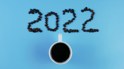 idea and creative number 2022, coffee cup and coffee beans on a blue background