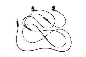 Black wired vacuum earplugs isolated on a white background. Headphones headset. In-ear headphones...
