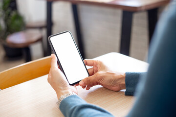 cell phone blank white screen mockup.hand holding texting using mobile on desk at office.background empty space for advertise.work people contact marketing business,technology