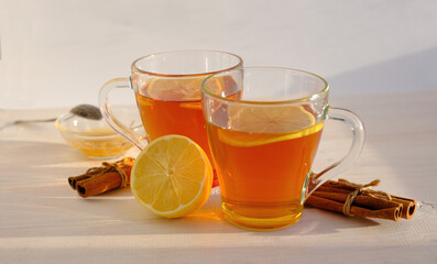 tea with lemon, cinnamon and honey, flat lay in warm colors