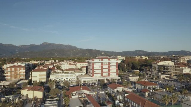 Drone Taking Off over Lido di Camaiore revealing Tuscan Hills behind the Town