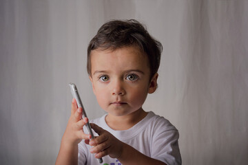 portrait of a little boy using a cell phone