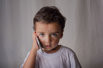portrait of a little boy talking on the cell phone