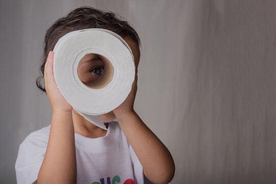 portrait of a little boy hugging a toilet paper