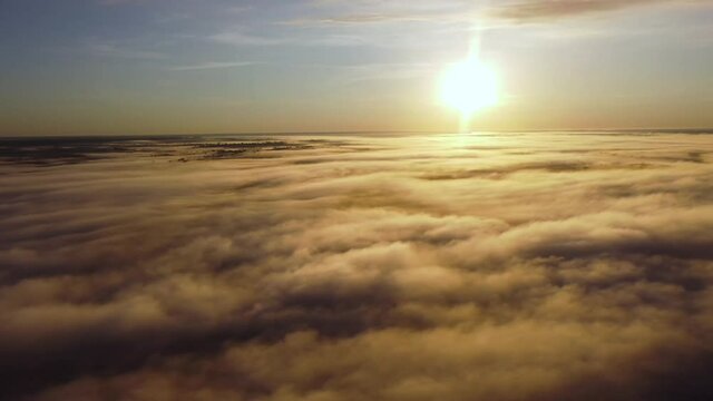 Sunrise above clouds, aerial view