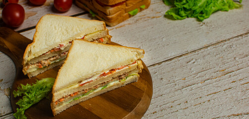 Classic homemade tuna sandwich with tomatoes,green oak,mayonnaise. Copy space. Top view. 
