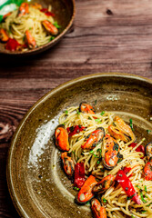 Homemade italian mussels spaghetti pasta with garlic and black pepper. Flavorful and comforting recipe. Presented with copy space, top view.
