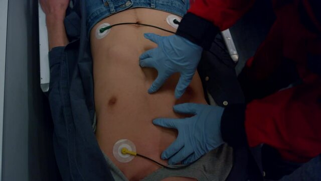 Ambulance doctor hands doing emergency CPR on patient. Paramedic rescuing man 