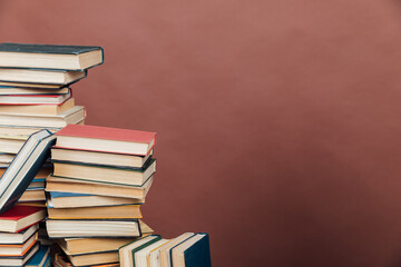 stacks of educational books for training in the college library as a background
