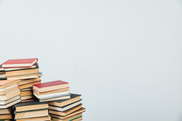 stacks of educational books for training in the college library as a background