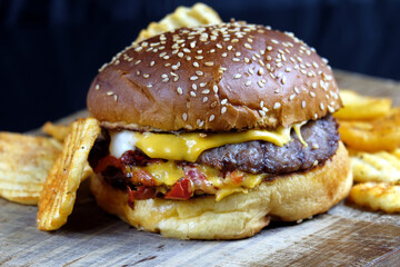 Close-up of home made tasty burger on wooden table.