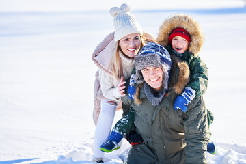 Nice happy family having fun on winter snow