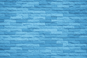 Brick wall painted with blue dark paint pastel calm tone texture background. Brickwork grid uneven bricks design stack backdrop.