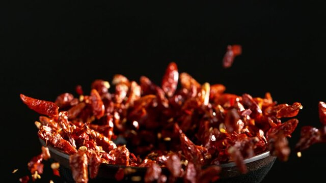 Super slow motion of crushing dry chilli peppers in grinder. Filmed on high speed cinema camera, 1000 fps.