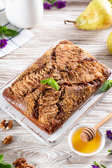 Homemade Chocolate Pear Cake. Ripened pears in a wooden background