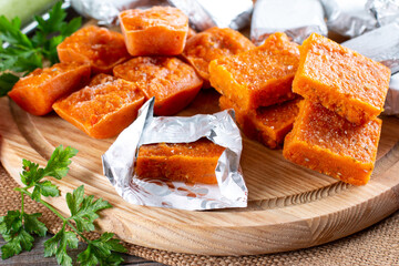 Frozen vegetable cubes on a cutting board. Life hacks, simple way to store vegetables