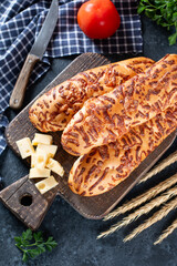 Cheese bread. Homemade Cheesy Breadsticks on a dark background