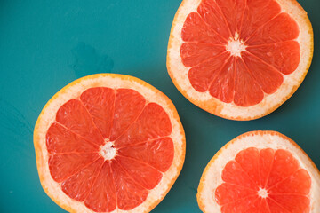 Sliced grapefruit on the blue background