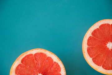 Sliced grapefruit on the blue background