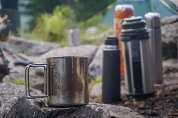 Hiking mug and thermos in nature