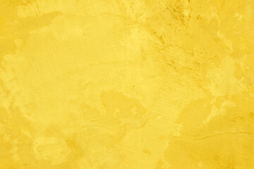Concrete wall yellow color for texture background. Abstract grunge bright colorful color yellow colored low contrast textured with roughness and irregularities.