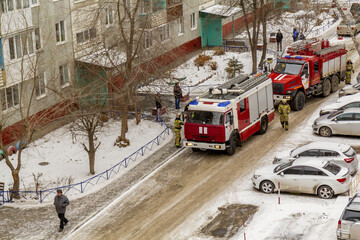 Omsk, Russia. 16 December, 2021. Fire in a residential multi-storey building. Two fire trucks...