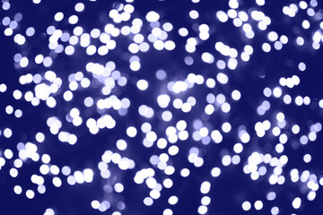 Beautiful natural bokeh of the purple lights. Abstract Christmas New Year backdrop for text or advertising. Template for banner or party invitation