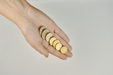 Top view of coins in hand. Concept of alms and donations. Small savings. Expenses and earnings.
