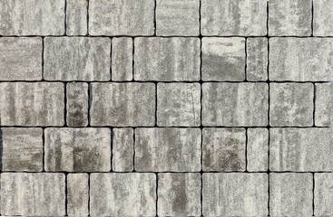 Snap lock tiles for exterior pavement made of gray granite mix. Background and texture