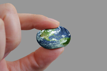 Fingers holding earth