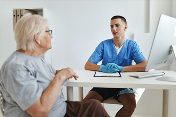 elderly woman patient is examined by a doctor professional consultation