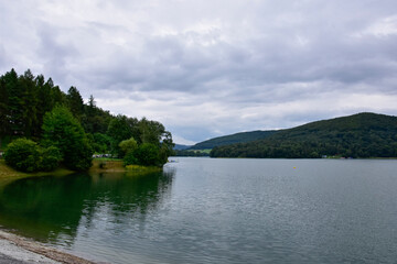 Fototapeta na wymiar Bieszczady Mountains, view of the artificial lake Solina, a Polish tourist attraction on a cloudy day during the holidays. 