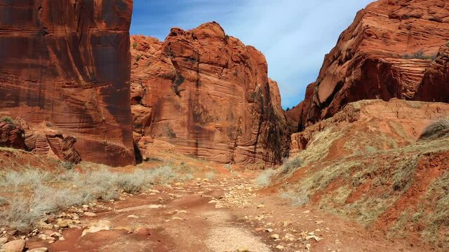 Forwarding shot of a colorful rocky landscape on a sunny day. Red Rock under sunny blue sky. Slot canyon, utah