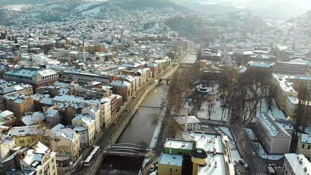 Snowy sunrise in Sarajevo. The Miljacka is the famous river that flows through this Bosnian capital. A drone shot capturing the fresh snow.