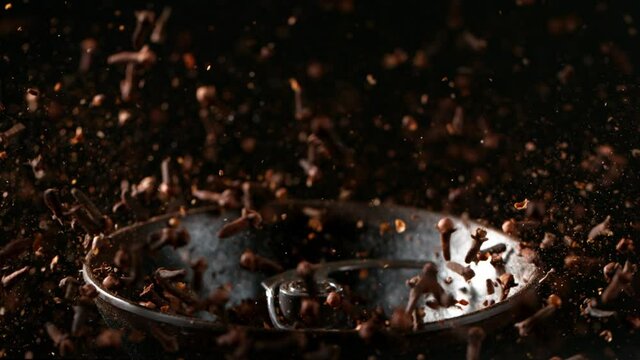 Super slow motion of crushing clove seeds in grinder. Filmed on high speed cinema camera, 1000 fps. Speed ramp effect.