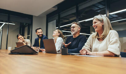 Cheerful businesspeople laughing during a meeting