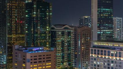 Dubai International Financial district aerial night timelapse. Panoramic view of business and financial office towers.
