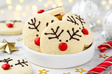 Christmas children's  dessert. Festive shortbread cookies or biscuits deer  in a white bowl.  Selective focus