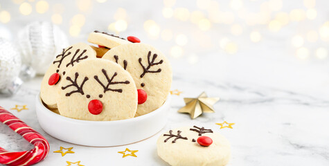Festive shortbread cookies or biscuits reindeer  in a white bowl. Christmas  dessert.  Close up. Selective focus