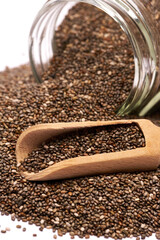 glass can full of organic natural chia seeds close-up isolated on white background