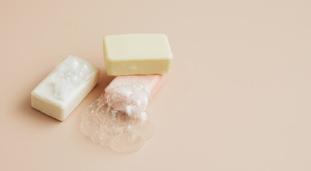 Natural organic handmade soap with large bubbles of foam on pastel background. Health beauty natural products concept. 