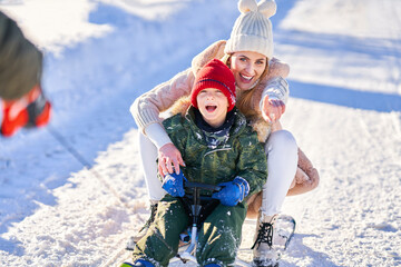 Nice happy family having fun on winter snow
