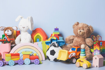 Kid toys collection isolated on blue background. Teddy bear, wooden, plastic and fluffy educational...