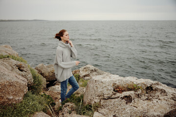 Fototapeta na wymiar portrait of a woman beach tourism cloudy weather stone coast unaltered