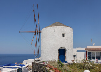 Traditional white windmill in Oia on the island of Santorini. Cyclades, Greece