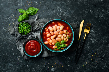 Traditional turkish food. Dried white beans with tomato paste in plate. Top view. On a stone background.